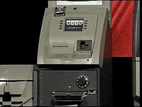 an animated GIF of an ATM dispensing wads of cash on stage at the Black Hat conference in 2010.