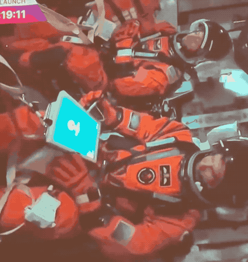 an animated GIF of one of the crew in the Artemis II shuttle ahead of launch typing in a passcode on their tablet from the camera.