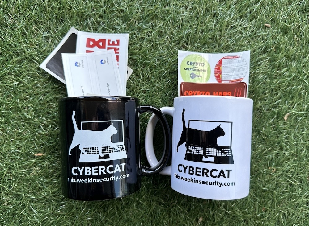 A selection of cyber cat and security-themed stickers, and a this week in security mug (each in both black and white mug colors).