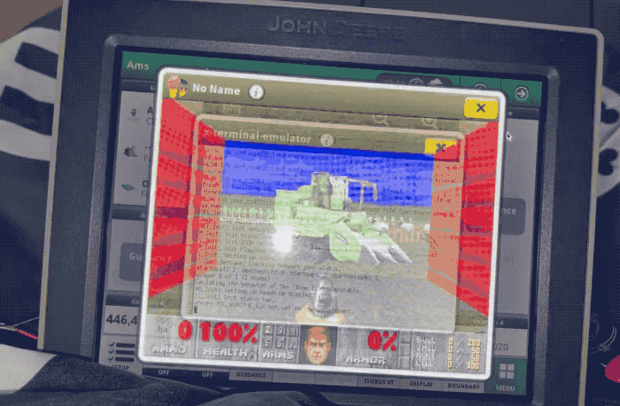 An animated GIF of Doom running on a John Deere tractor display. Doom has been modded to replace a gun with a steering wheel.